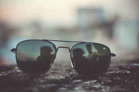 focus photo of black aviator style sunglasses on surface