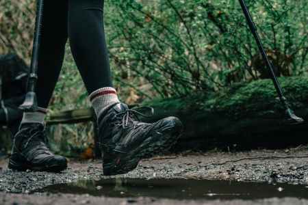 low angle shot of a person wearing hiking shoes