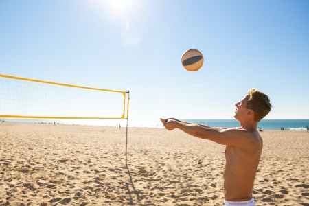 man playing volleyball on the beach