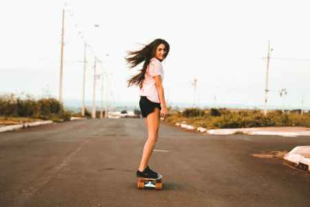 woman riding skateboard at the road