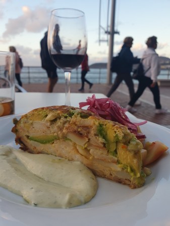 picture of tortilla with avocado and a glass of wine