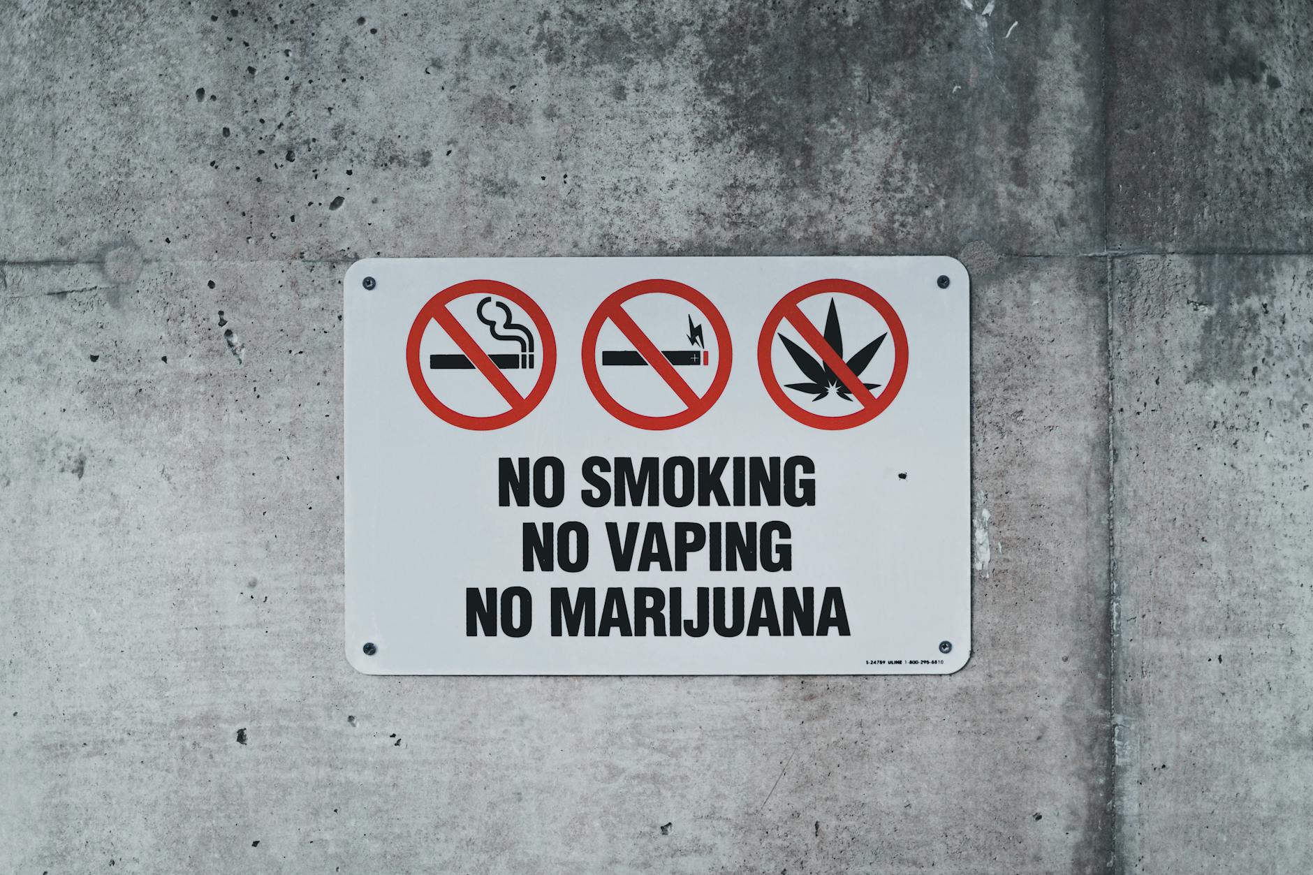 a sign forbidding smoking attached to a wall